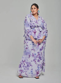 A woman dressed in Lilac Tun Hamidah Chiffon Wrap Kurung