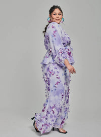 A woman dressed in Lilac Tun Hamidah Chiffon Wrap Kurung