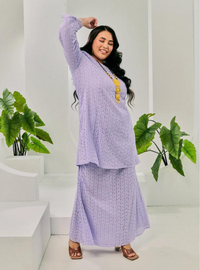 A woman dressed in Lilac Tun Inna Kurung