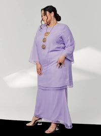 A woman dressed in Lilac Tun Sharimah Organza Kurung