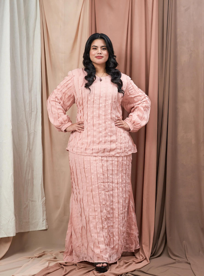 A woman dressed in Pink Ms Aminah 3D Pleated Frizzy Kurung Modern