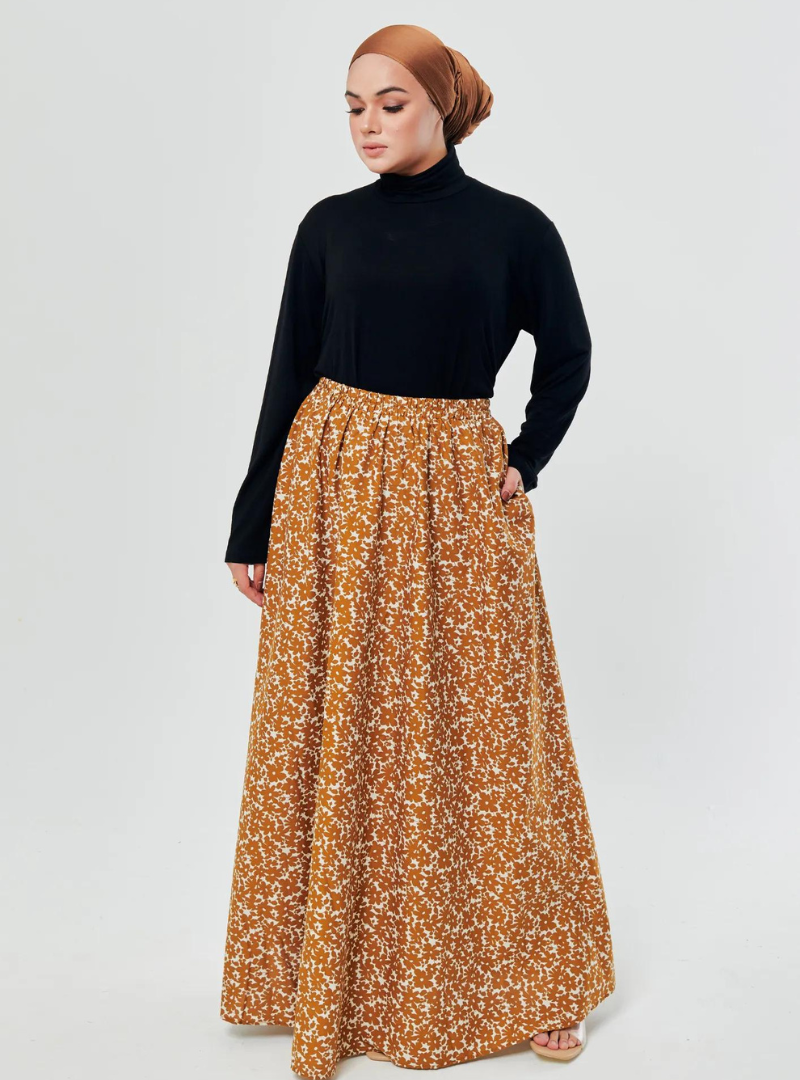 A woman wearing Mustard English Printed Cotton Maxi Skirt