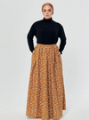 A woman wearing Mustard English Printed Cotton Maxi Skirt