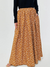 A woman wearing Mustard English Printed Cotton Maxi Skirt