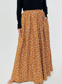 A woman wearing Mustard English Printed Cotton Maxi Skirt