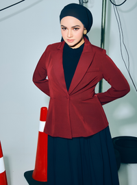 A woman wearing in Maroon Amber Peplum Blazer