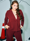 A woman wearing in Maroon Amber Peplum Blazer