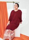 A woman dressed in Maroon Tun Bedah Top