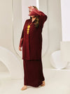 A woman dressed in Maroon Tun Jamilah Pletated Kebarung