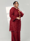 A woman dressed in Maroon Tun Sharimah Organza Kurung