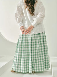 A woman wearing Mint Green Jane Checked Skirt