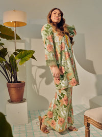 A woman dressed in Mint Green Tun Anum Printed Wrap Kurung