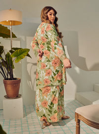 A woman dressed in Mint Green Tun Anum Printed Wrap Kurung