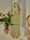 A woman dressed in Mint Green Tun Malika Feather Wrap Kurung