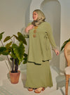 A woman dressed in Mint Green Tun Malika Feather Wrap Kurung