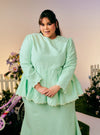 A woman dressed in Mint Green Tun Zera Eyelet Kurung