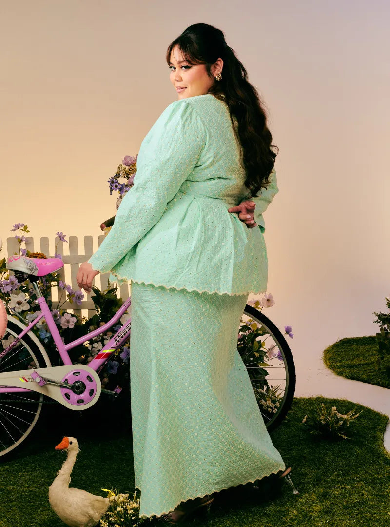 A woman dressed in Mint Green Tun Zera Eyelet Kurung