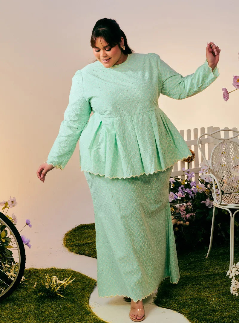 A woman dressed in Mint Green Tun Zera Eyelet Kurung