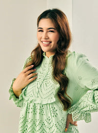 A woman dressed in Mint Green Ezzah Eyelet Doll Top