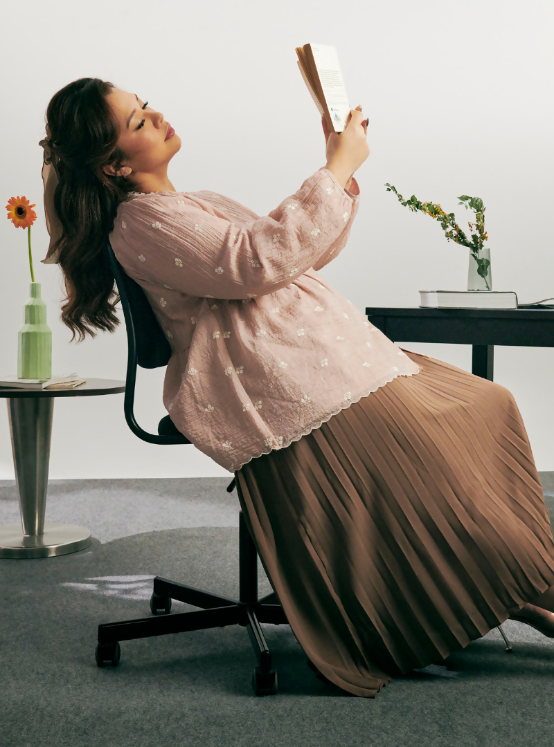 A woman dressed in Mocha Nude Arya Peplum Embroidered Top