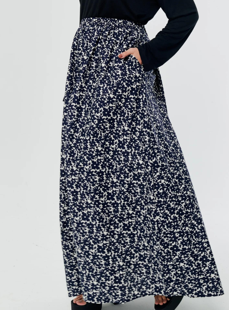 A woman wearing Navy English Printed Cotton Maxi Skirt