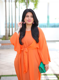 A woman dressed in Burnt Orange Nelydia Pario Wrap Only