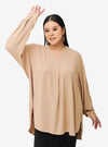 A woman dressed in Nude Mandarin Collar Oversized Shirt