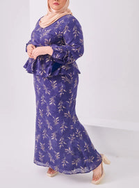 A woman dressed in Navy Padi Tun Umaiyah Padi Chiffon Wrap Kurung