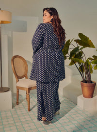 A woman dressed in Navy Tun Maryam Eyelet Kurung