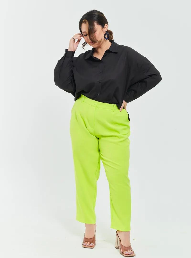 A woman wearing Neon Green Skinny Tuxedo Trouser