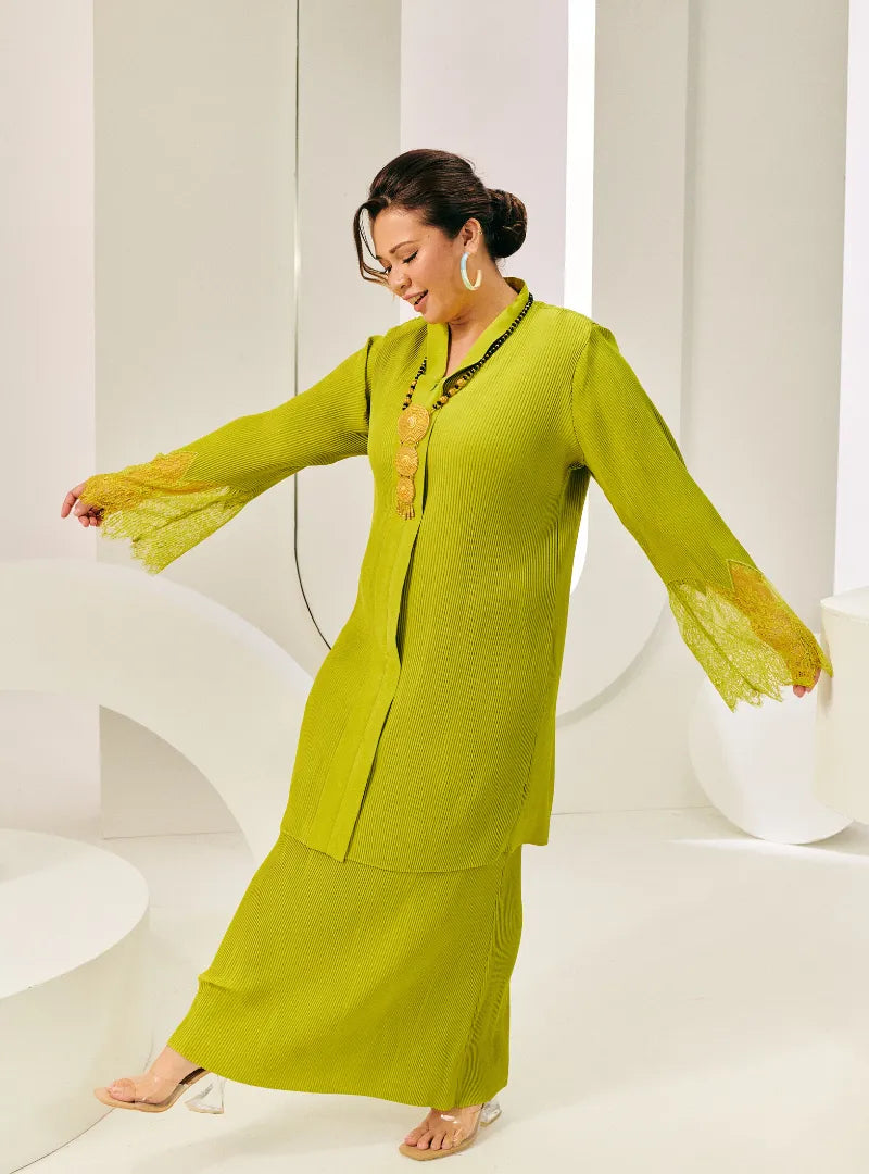 A woman dressed in Neon Green Tun Jamilah Pletated Kebarung