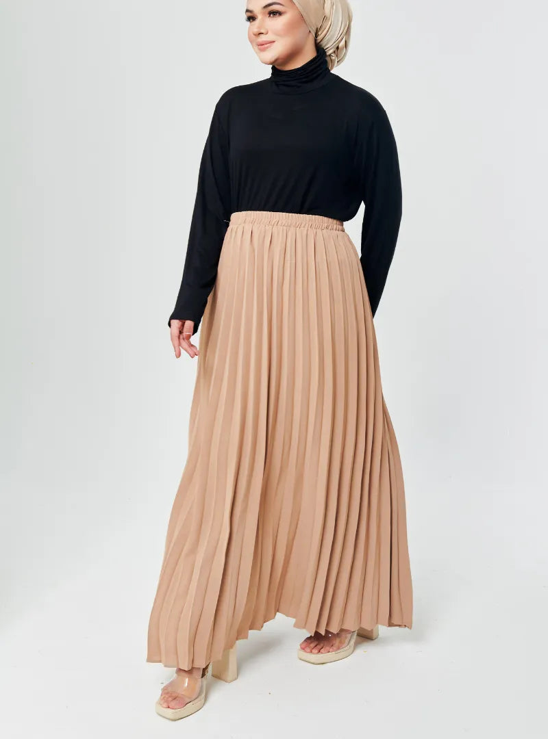 A woman wearing Nude Basic Pleated Skirt