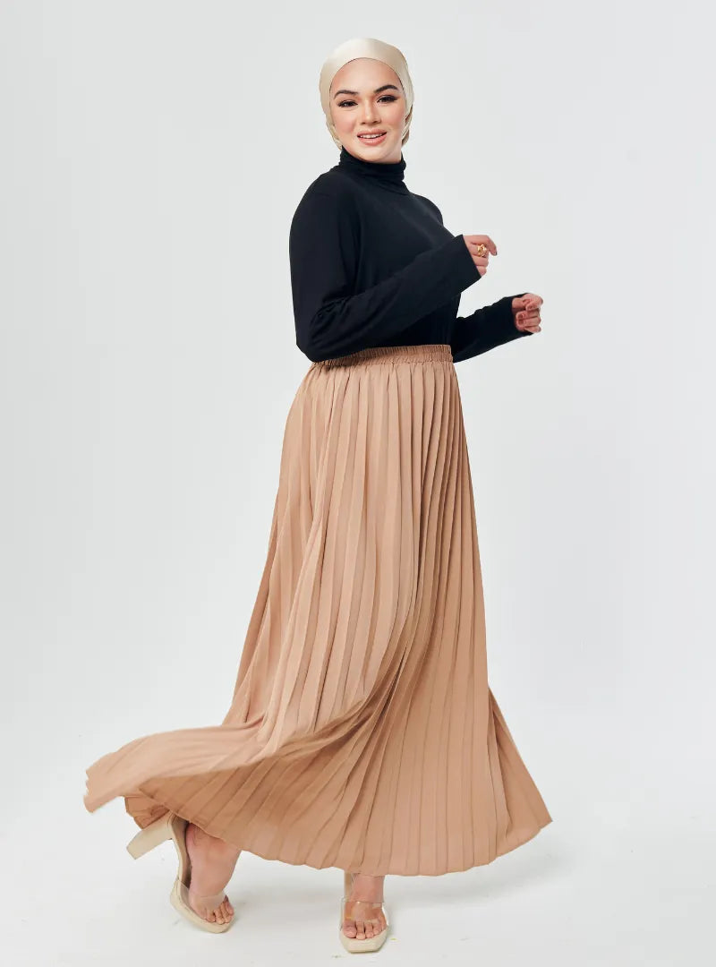 A woman wearing Nude Basic Pleated Skirt