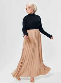 A woman wearing Nude Basic Pleated Skirt