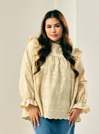 A woman dressed in Nude Sand Miza Cotton Broderies Eyelet Top