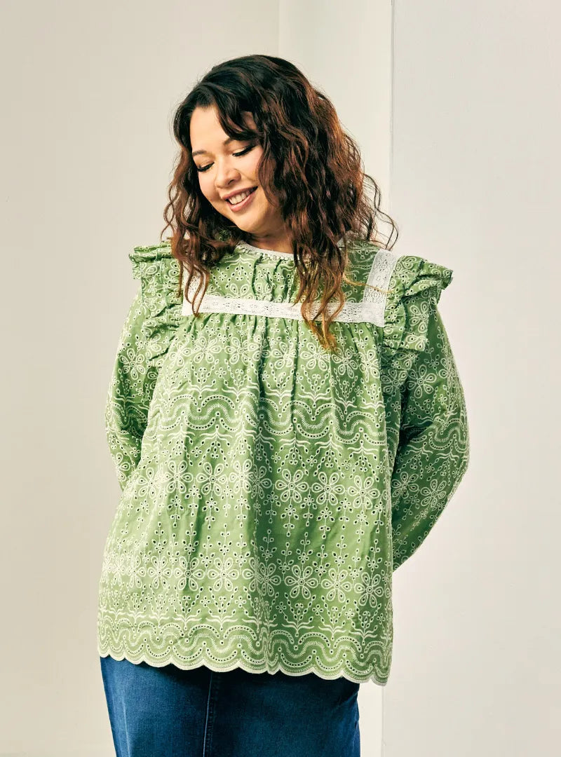 A woman dressed in Olive Miza Cotton Broderies Eyelet Top