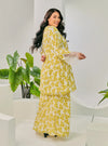 A woman dressed in Olive Tun Kuntom Cotton Lace Kurung