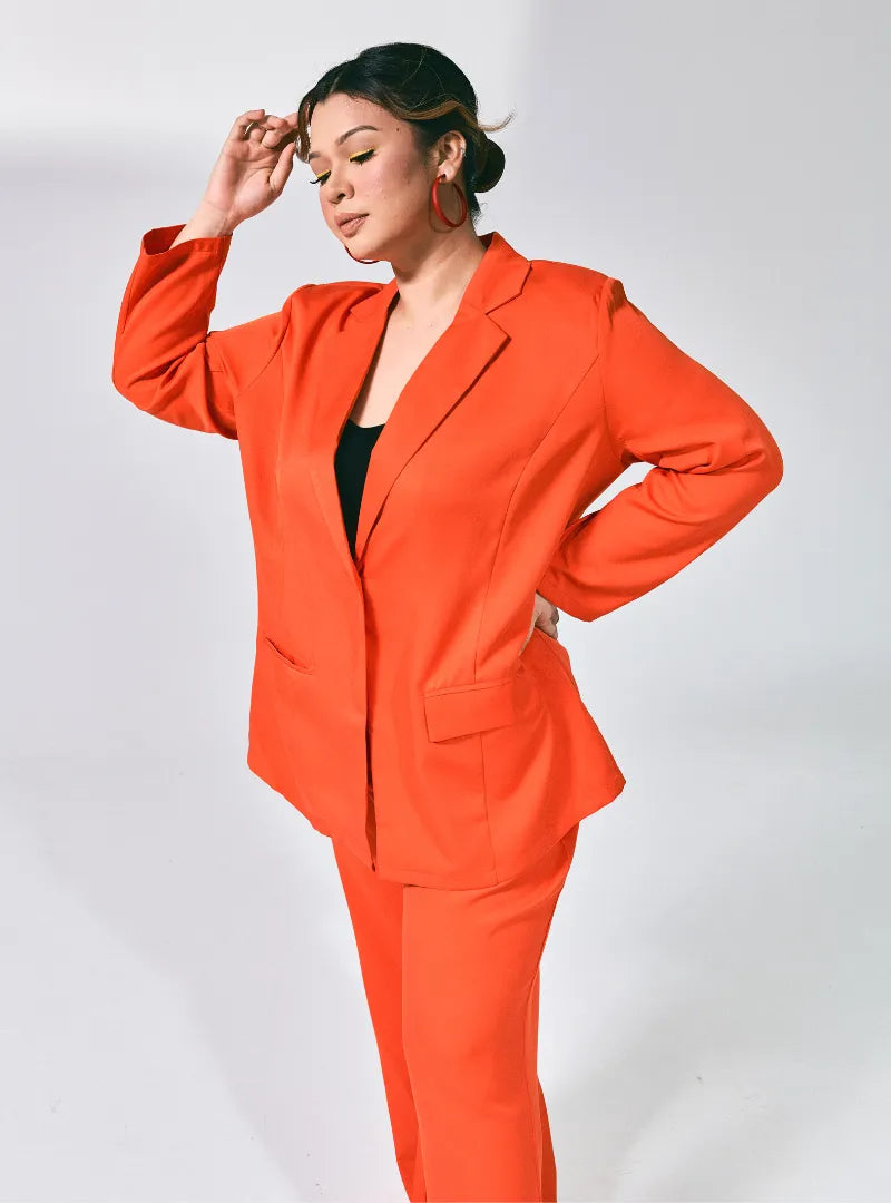 A woman dressed in Orange Lapel Collar Oversized Blazer