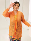 A woman dressed in Orange Tun Basirah Kebaya Lace Nyonya