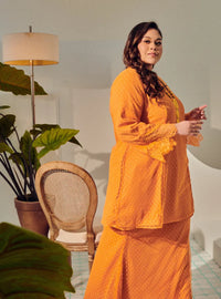 A woman dressed Orange Tun Melur Dotted Kurung Pahang-