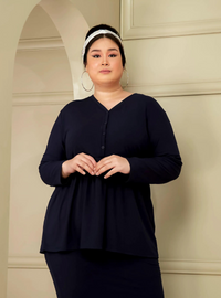 A woman dressed in Navy Peplum Button Front Knit Top