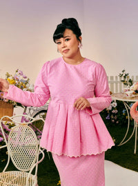 A woman dressed in Pink Doll Tun Zera Eyelet Kurung