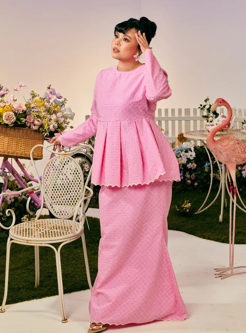 A woman dressed in Pink Doll Tun Zera Eyelet Kurung