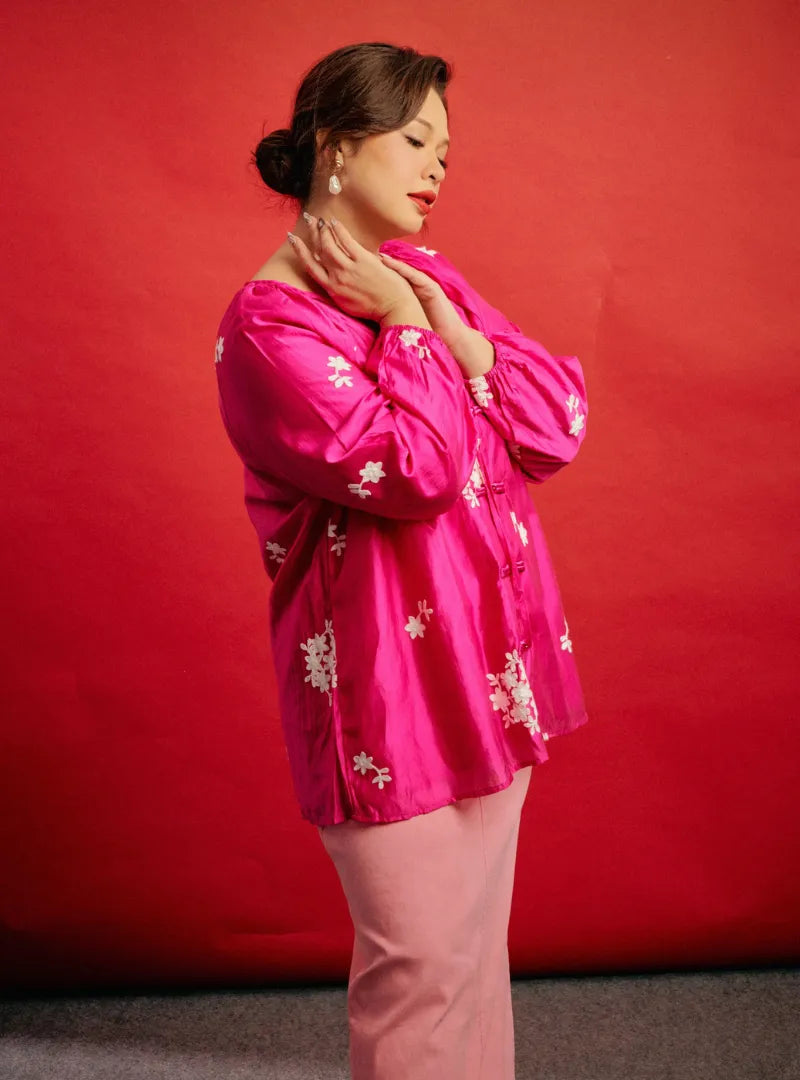 A woman dressed in Pink Goddess Wong Gu Embroidered Cheongsam Top