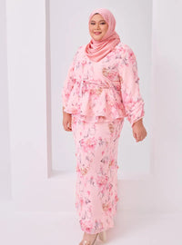 A woman dressed in Pink Tun Hamidah Chiffon Wrap Kurung