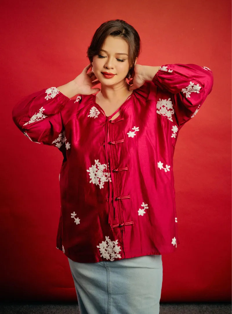 A woman dressed in Plum Babe Wong Gu Embroidered Cheongsam Top