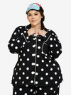 A woman dressed in Black Polka Dotted Pyjamas