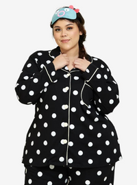 A woman dressed in Black Polka Dotted Pyjamas