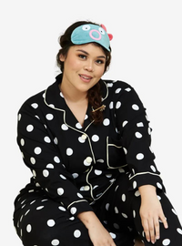 A woman dressed in Black Polka Dotted Pyjamas