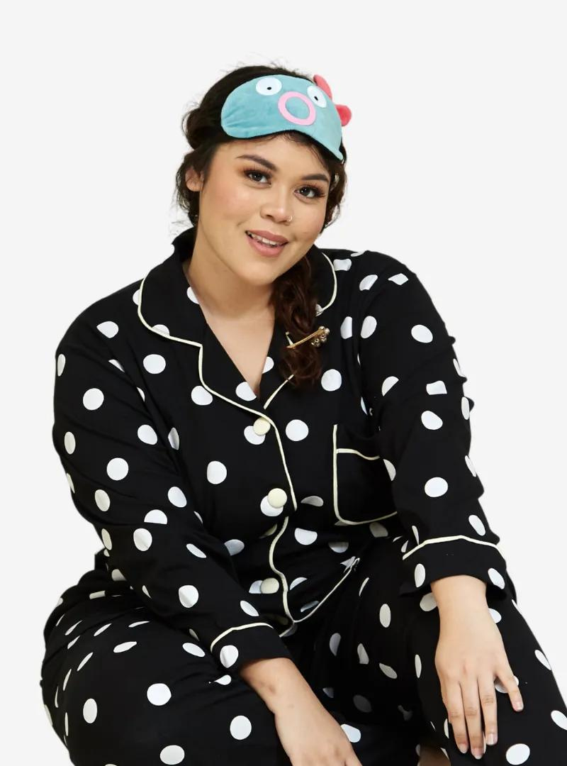 A woman dressed in Black Polka Dotted Pyjamas